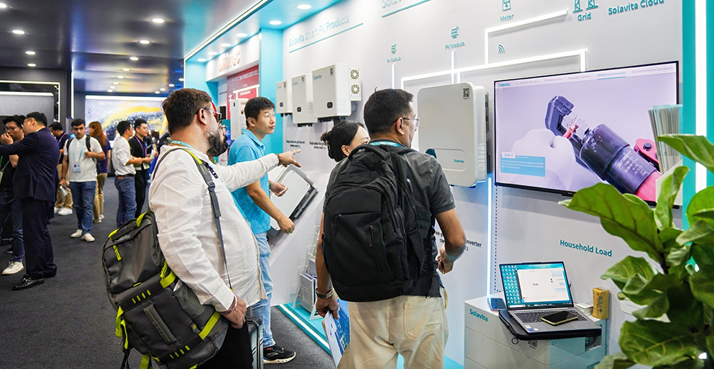 Solavita exhibition booth showcasing inverters and solar solutions, with product demonstration video and customer interaction at trade show