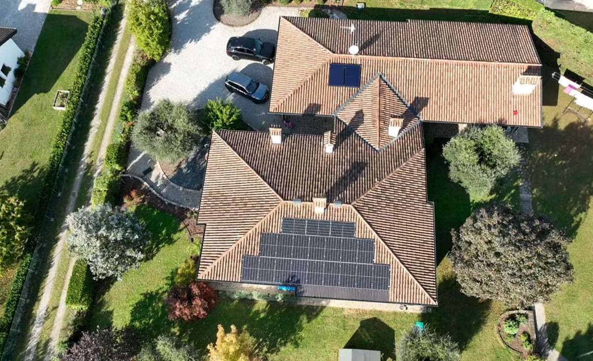 Aerial view of a residential rooftop solar system installed on a red-tile villa in Germany, highlighting clean energy integration in premium housing