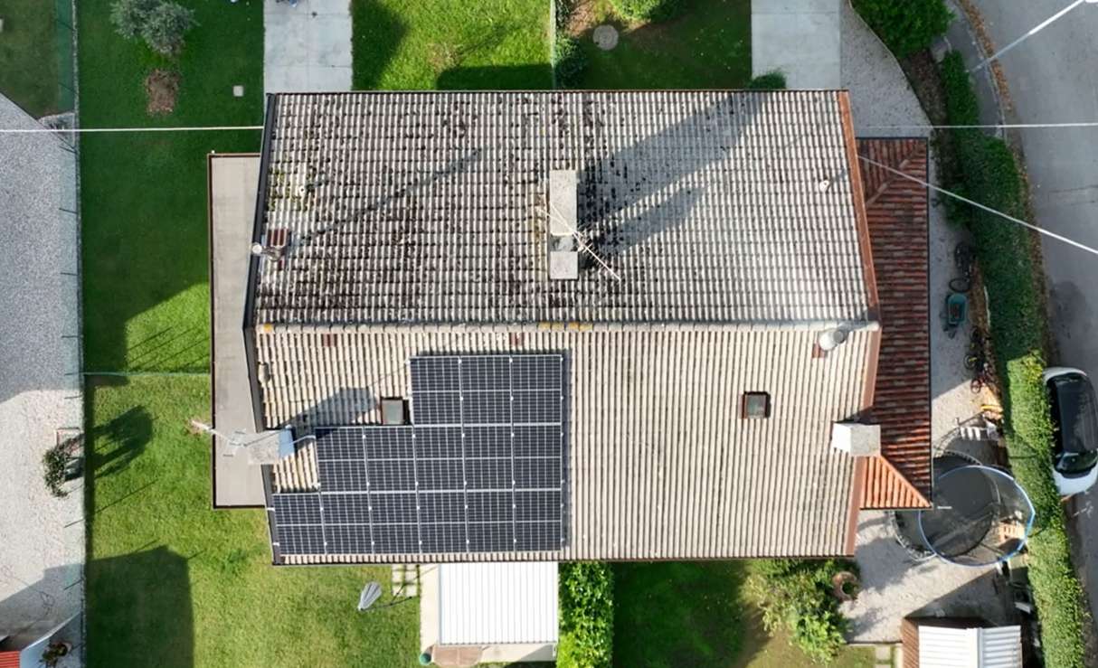 Aerial view of a residential rooftop solar system installed on a tiled roof in Europe, showcasing a real-world application of Solavita photovoltaic panels