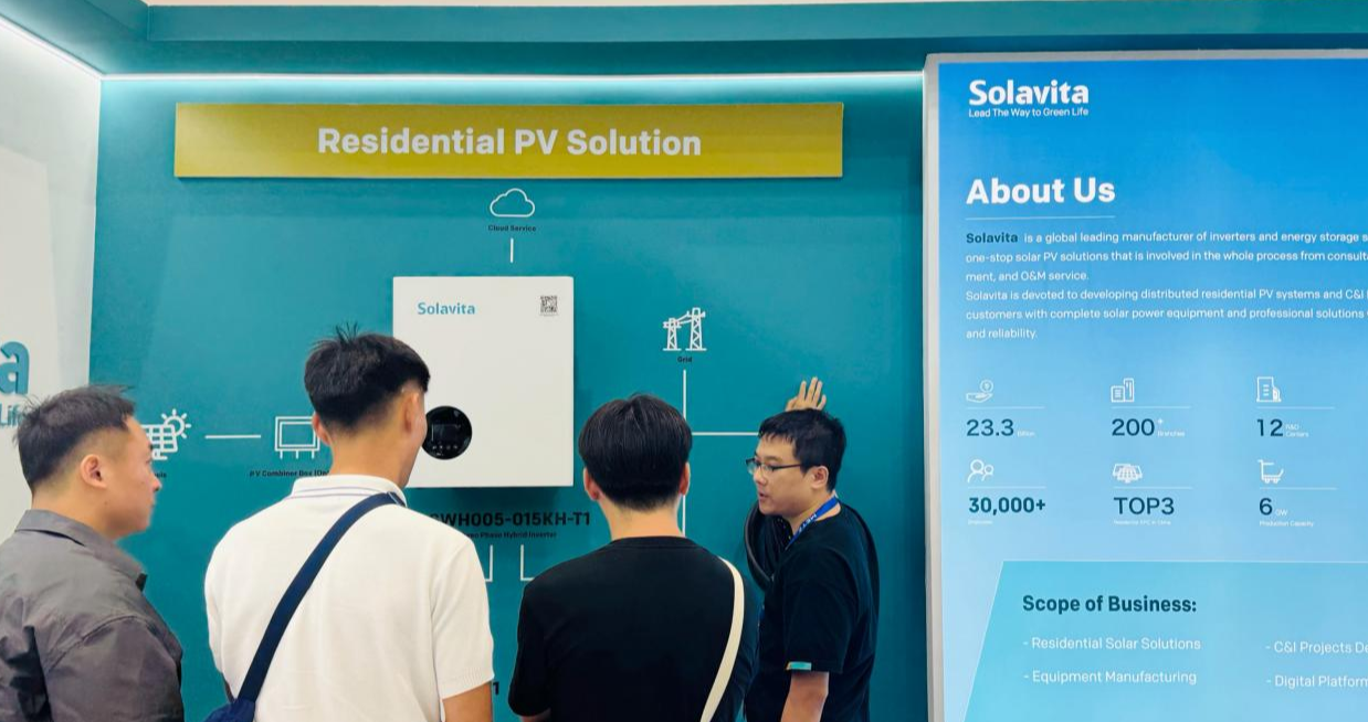 Skyworth staff explaining residential PV solution with hybrid inverter to visitors at a solar energy exhibition booth