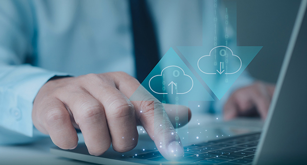 Businessman using laptop to manage cloud data upload and download, symbolizing smart platform and digital energy solutions