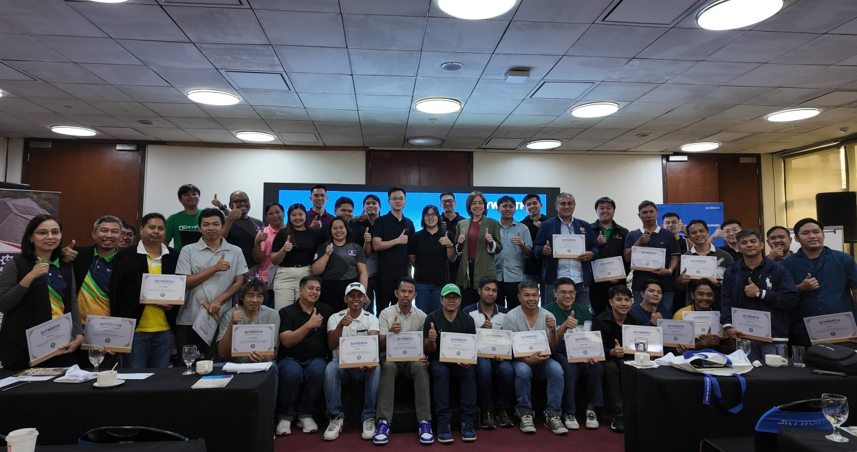 Group of participants at Solavita's solar and energy storage installer event in the Philippines, celebrating after completing training, holding Skyworth certificates